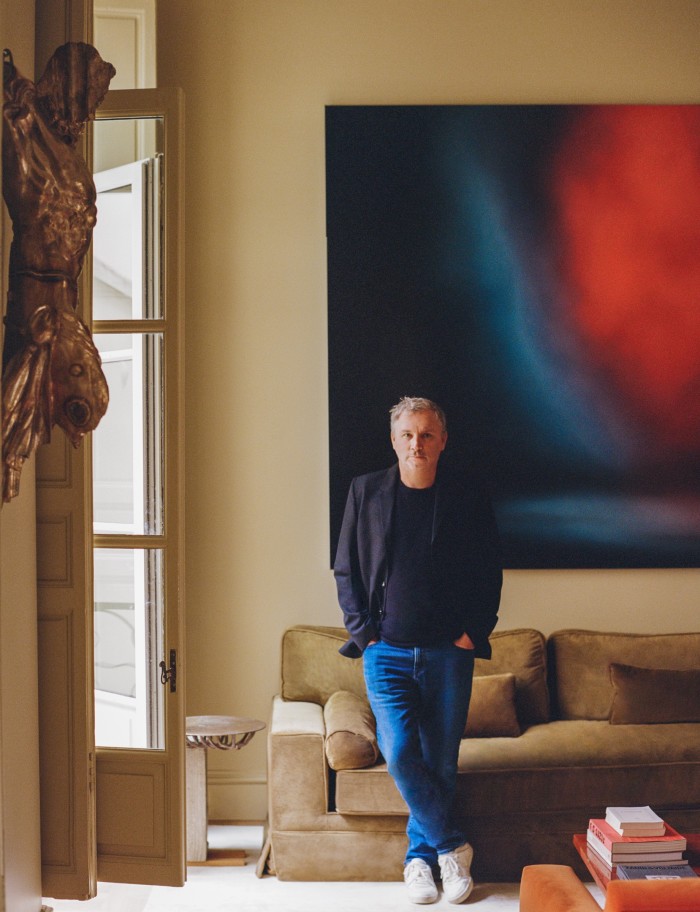 Thierry Gillier in the antichambre. He stands in front of Stage III, 2022, by Anne Imhof. On the wall to his right is Untitled, 2020, by Danh Vo