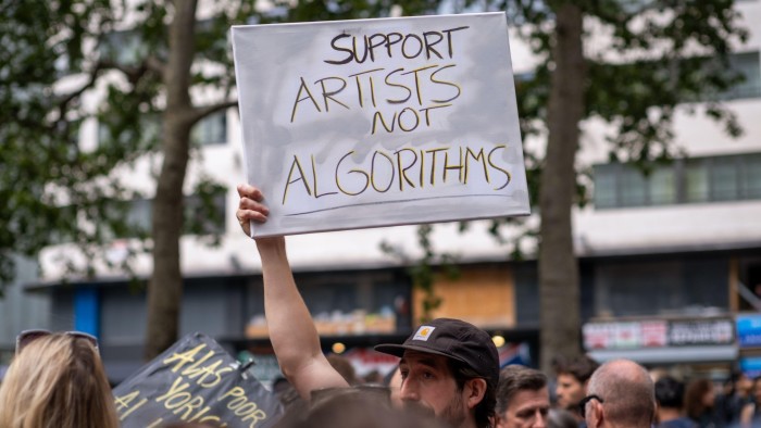 A protester holds a placard against use of AI at an Equity actors union rally in London
