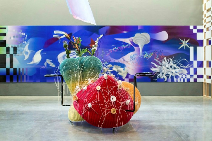 Large woolly fruit and vegetable-like sculptures with white hair