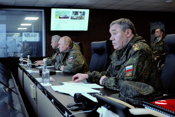 Putin, centre, with his defence minister, Sergei Shoigu, left, and Valery Gerasimov, chief of the general staff