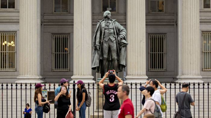 Visitors take photographs outside the US Treasury building in Washington, DC, on August 13 2019