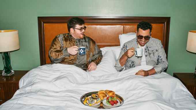 Steven Stokey-Daley (left) and Dan Levy in the Royal Suite at London’s St Pancras Hotel. Stokey-Daley wears DL Eyewear x SS Daley Cloudsley in Khaki, $200. SS Daley upcycled-silk James shirt, £500. Levy wears DL Eyewear x SS Daley Charlton in Umber, $200. SS Daley cotton shirt, £550