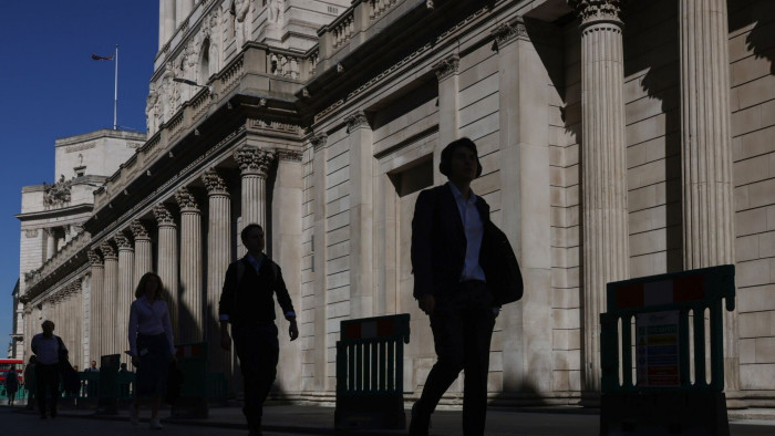 Pedestrians pass the Bank of England