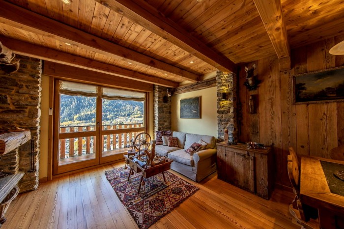 wood panelled interior with view to snowy mountains