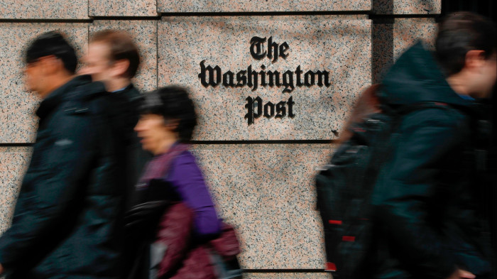 People walk pat the Washington Post building