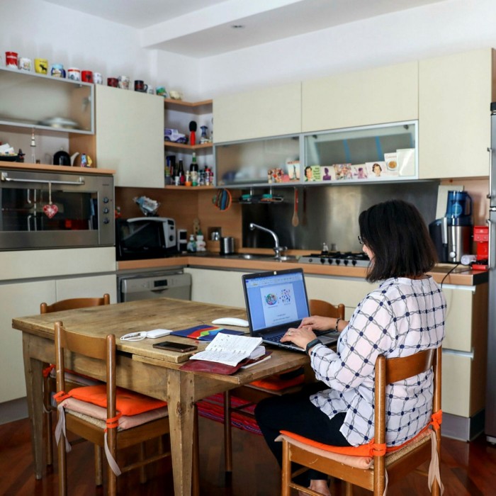 A woman works at home in Rome. Across Europe, nearly 40 per cent of employees worked remotely in the first half of the year, according to the European Commission
