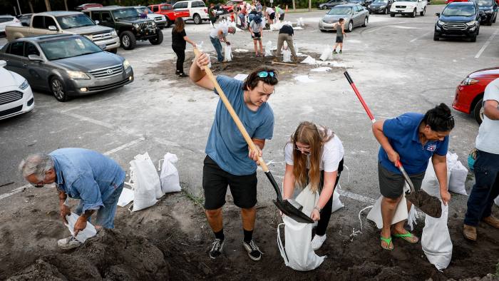 People fill sandbags at Helen Howarth Park as they prepare for the possible arrival of Hurricane Ian