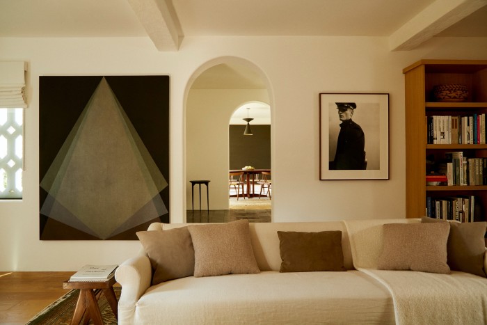 The Clements Design linen sofa in the living room. On the wall (from left) are Veladura Nocturna, 2018, by Mexican artist Gonzalo Lebrija and Game Keeper, a 2004 photograph by Collier Schorr