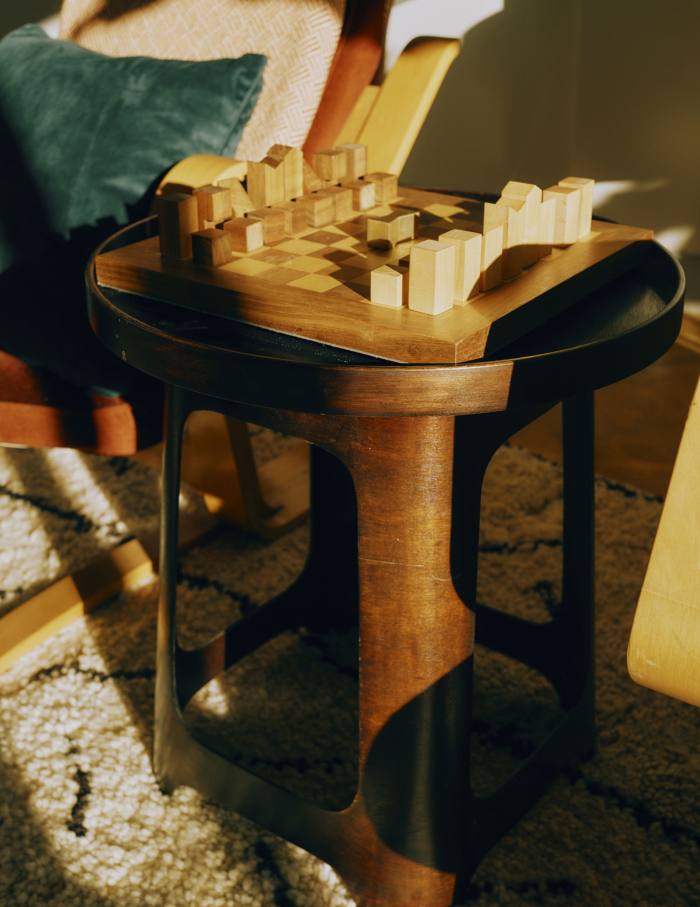 A 1930s Isokon stool and Cubitts chess set