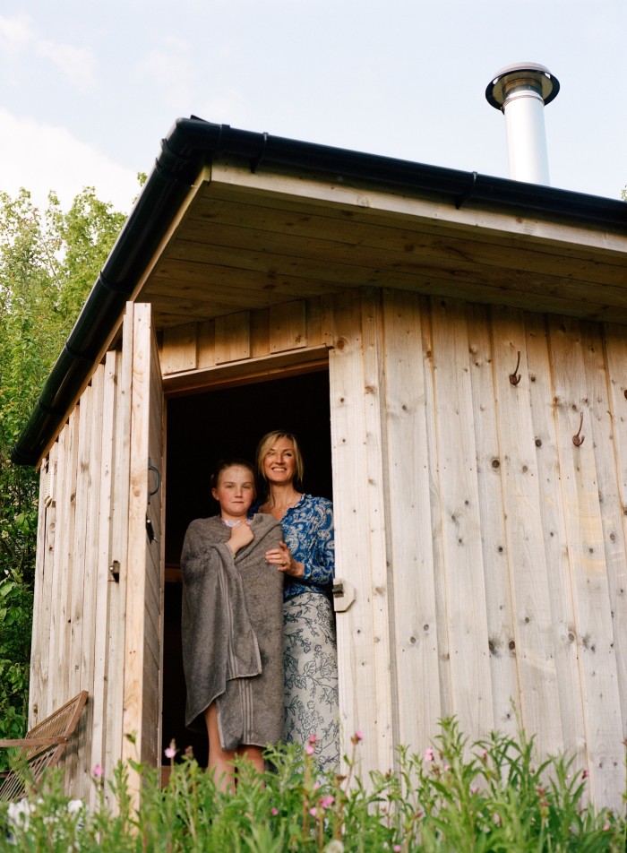 Sonja Dineley and her daughter Dorothy in the sauna on their farm in Wiltshire