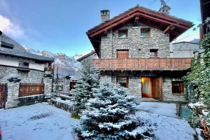 exterior of a snowy chalet with balcony