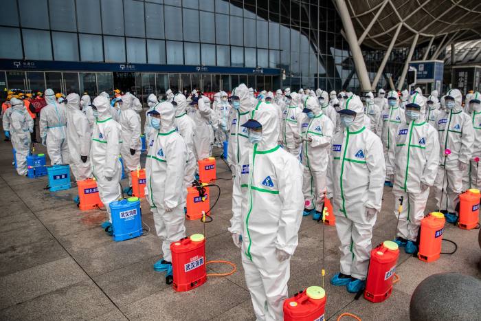 Staff prepare to spray disinfectant at Wuhan Railway Station in early March. 