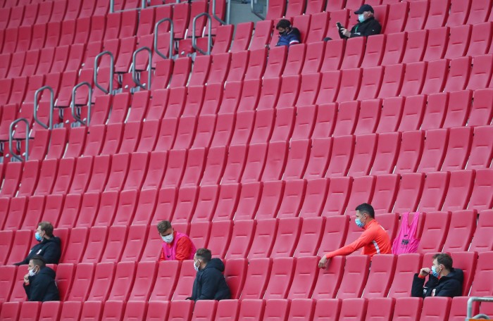 FC Augsburg substitutes remain socially distanced as they sit in the stands during the Bundesliga game against Cologne last month. Under new temporary laws, five subs can be introduced during a match, up from three