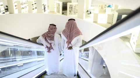 Two men on an escalator in Saudi Arabia