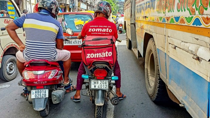 A Zomato food delivery driver is seen in traffic in Kolkata, India. The group’s shares have doubled from its issue price to a $15bn valuation despite scepticism over its cash burn