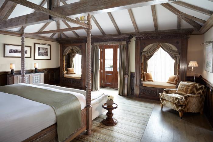 The hand-carved four-poster bed and wood panelling in The Prince’s Lodge suite