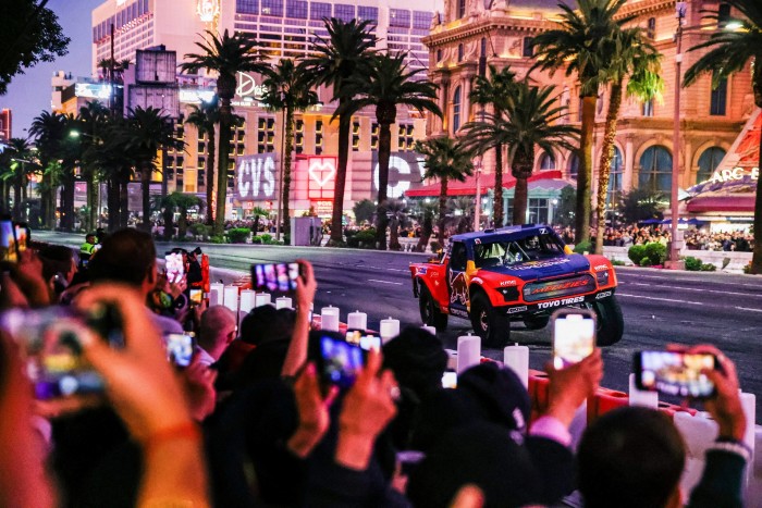 a Red Bull race car doing a run in front of a crowd at Las Vegas