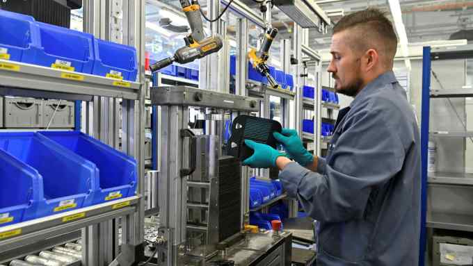 a man works on cells for hydrogen generation modules at Germany’s Sunfire firm