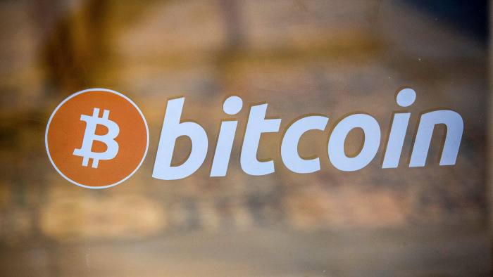 A bitcoin logo on the window of a cryptocurrency exchange in Barcelona, Spain