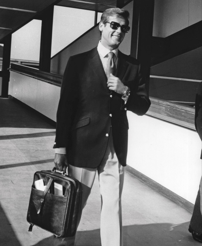 Roger Moore exudes jet-set style at Heathrow airport, 1973