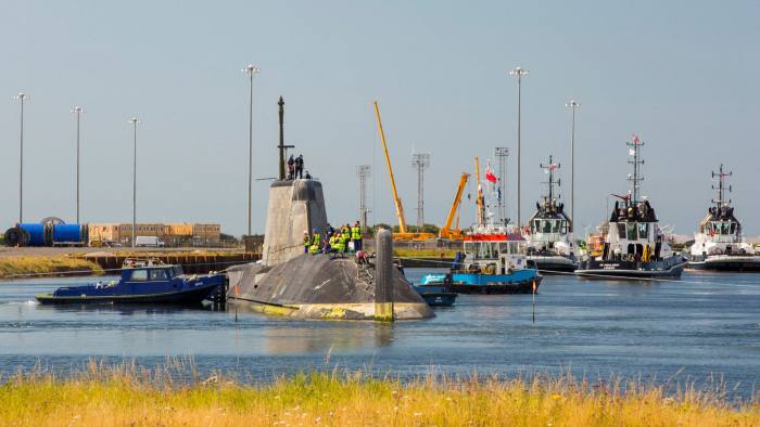 A nuclear-powered submarine is moved from Barrow-In-Furness to the Faslane submarine base in Scotland