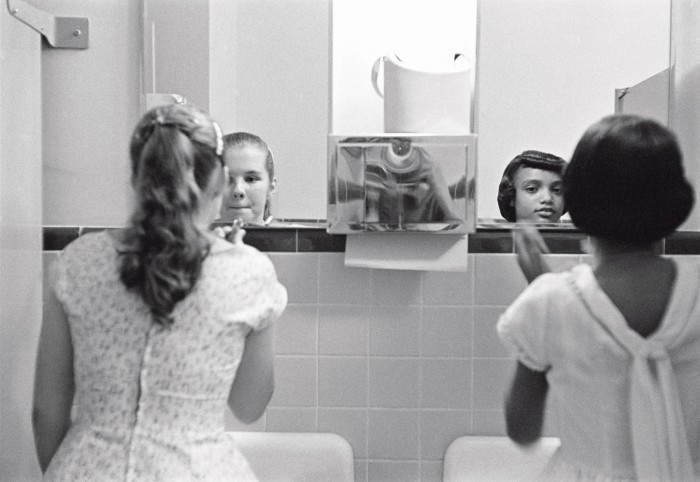 Two girls apply make-up in the ladies’ room before an integration dinner party during a civil-rights strike in Virginia, US, 1958