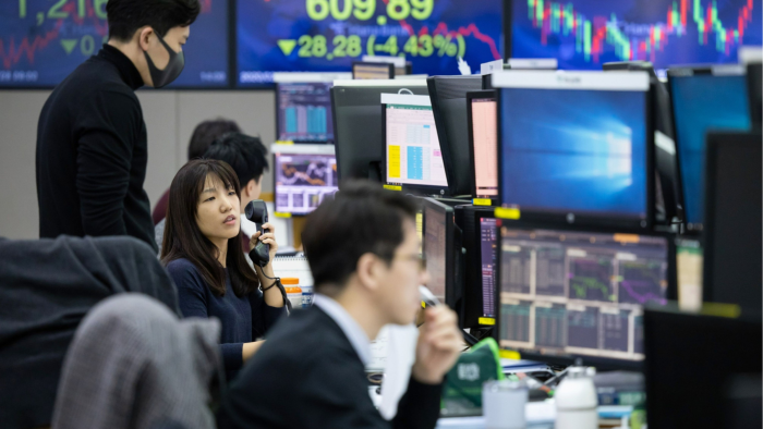Foreign currency dealers work in a dealing room of Hana Bank in Seoul, South Korea