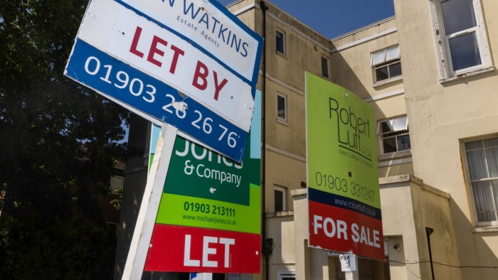 Estate agents’ ‘Let By’ and ‘For Sale’ signs outside a residential property in Worthing, UK