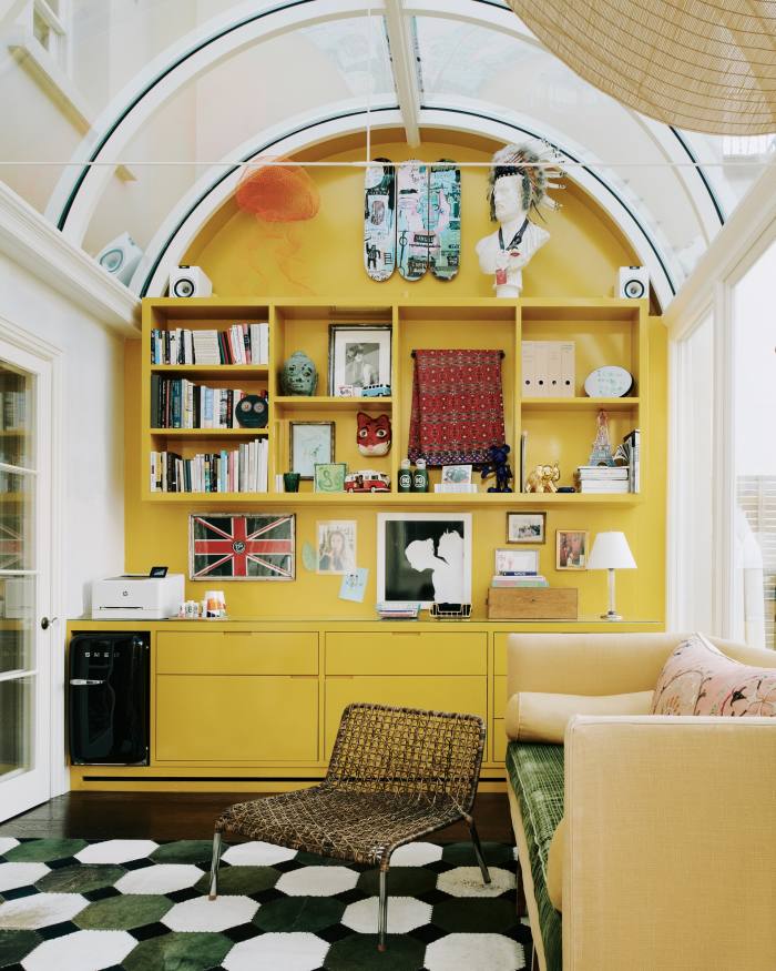 Dawn’s office in the conservatory features three Basquiat skateboards at the top of the yolk-yellow wall