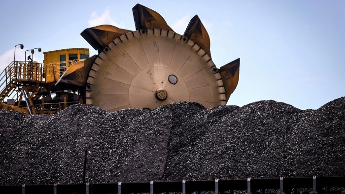 A bucket-wheel reclaimer next to a pile of coal at the Port of Newcastle in Australia