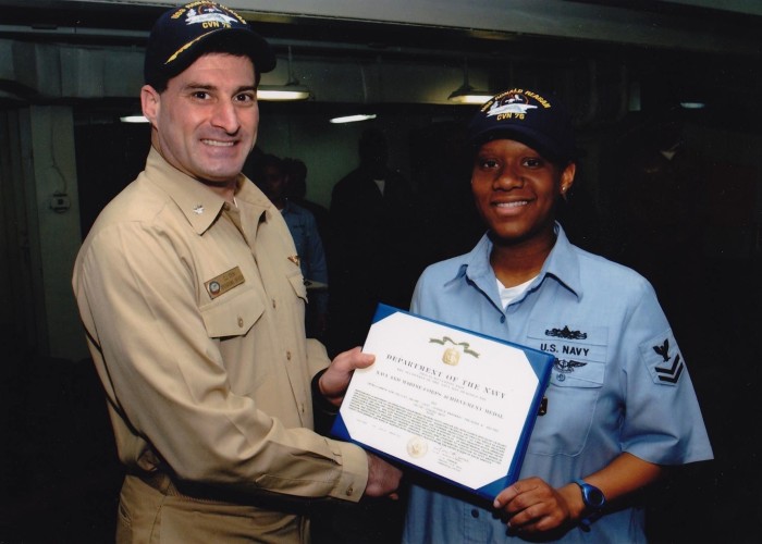 Waites-Thierry receives an achievement medal while serving in the US Navy