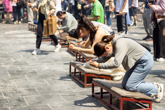 People pray at the Lama Temple in Beijing