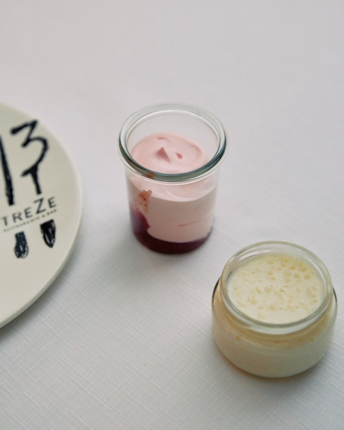 Glass pots of strawberry mousse and rice pudding at Treze