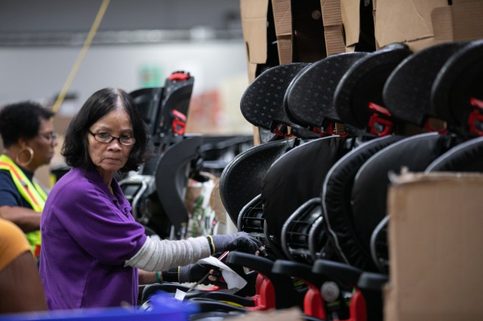 Workers making car seats in a factory