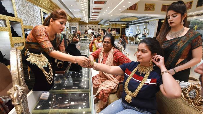 People buy jewellery at a showroom