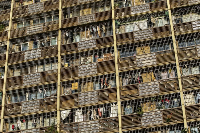 Laundry hangs out of windows at a residential building in Chongqing. While China's wealthier citizens have emerged largely unscathed financially from the pandemic, many on low incomes are struggling