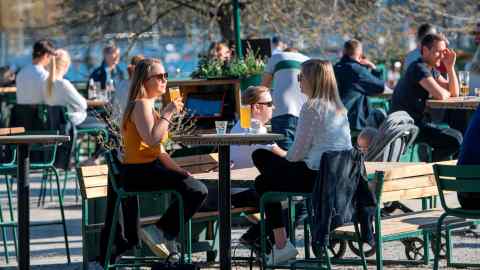 People socialise in Stockholm on April 22 as the country’s approach to dealing with coronavirus comes under scrutiny