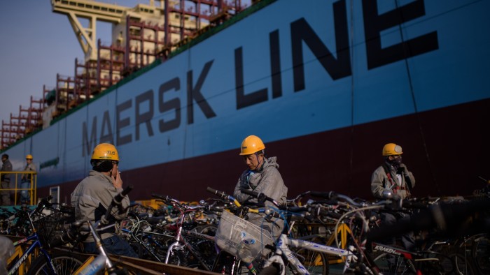 workers taking a break outside an under-construction Maersk triple-E class container ship