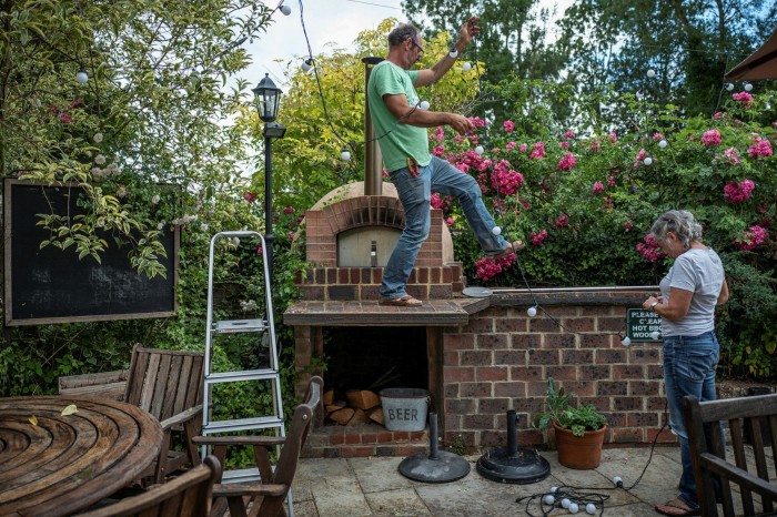 Neighbours lend a hand in the garden to get the Griffin ready for reopening