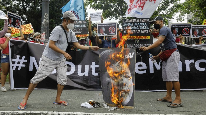 Protesters burn images of presidential candidate Ferdinand ‘Bongbong’ Marcos Jr. and vice-presidential candidate Sara Duterte in Metro Manila