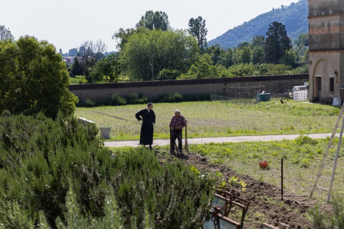 A monk and an employee of the Abbazia di Praglia work on the vegetable patch