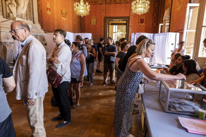 Voters queue at a polling station in Marseille City Hall.
