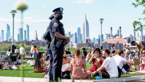 Police patrol Domino Park in Brooklyn, where New Yorkers can gather under social distancing rules