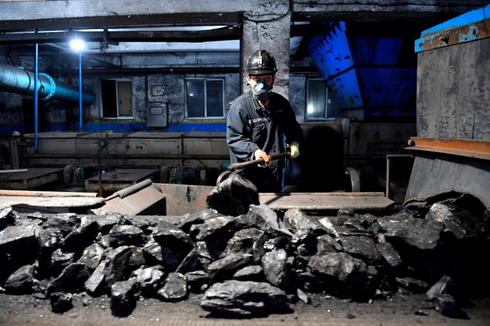 A worker sorts coals at the Qianyingzi mine in Suzhou, Anhui province