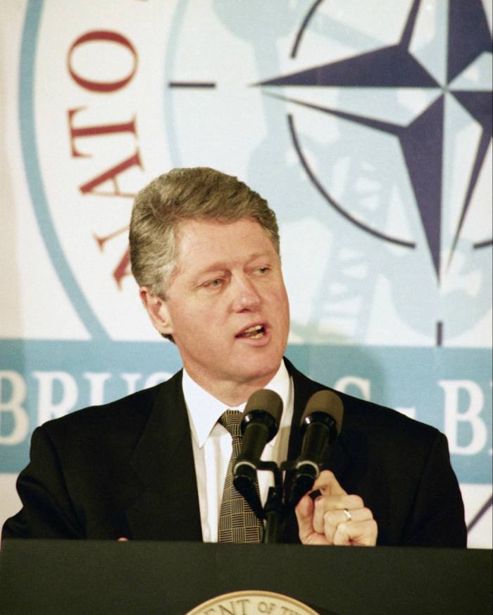 Bill Clinton at a Nato podium, speaking to the press in 1994