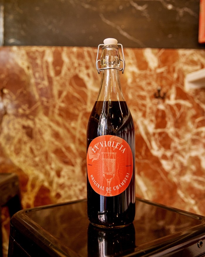 A bottle of red vermouth on a table at La Violeta