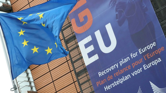An EU flag and a sign outside the European Commission headquarters