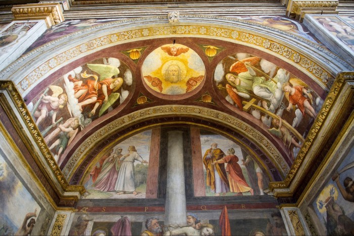 An ornate painted archway of religious scenes at San Maurizio al Monastero Maggiore