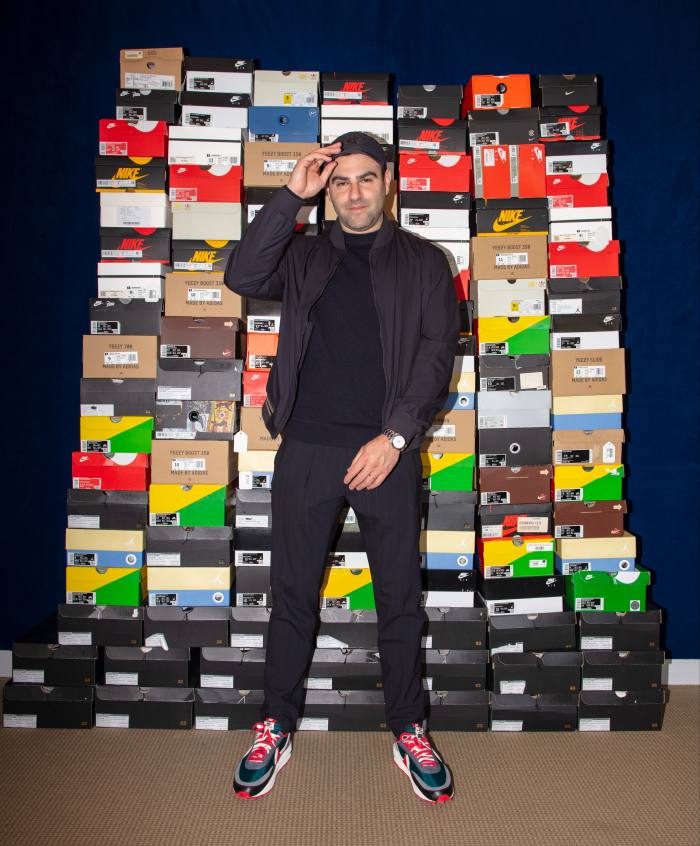 Brahm Wachter of Sotheby’s standing in front of a stack of shoeboxes