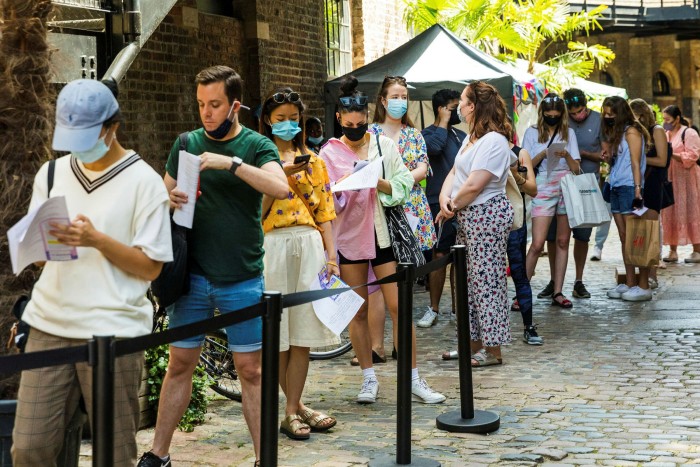 People queue at a pop-up Covid-19 vaccination centre in Camden, London